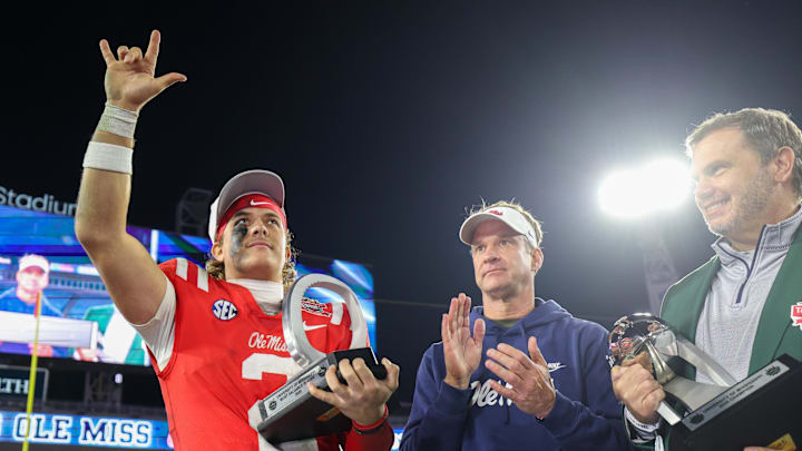 Jan 2, 2025; Jacksonville, FL, USA;  Mississippi Rebels quarterback Jaxson Dart (2) is given the MVP award after beating tubes Duke Blue Devils in the Gator Bowl at EverBank Stadium. Mandatory Credit: Nathan Ray Seebeck-Imagn Images