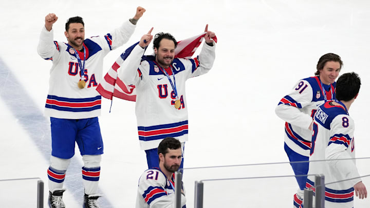 Feb 22, 2026; Milan, Italy; Auston Matthews of the United States (center) celebrates with teammates after winning the men's ice hockey gold medal game during the Milano Cortina 2026 Olympic Winter Games at Milano Santagiulia Ice Hockey Arena. Mandatory Credit: James Lang-Imagn Images Feb 22, 2026; Milan, Italy; Auston Matthews of the United States (center) celebrates with teammates after winning the men's ice hockey gold medal game during the Milano Cortina 2026 Olympic Winter Games at Milano Santagiulia Ice Hockey Arena. Mandatory Credit: James Lang-Imagn Images