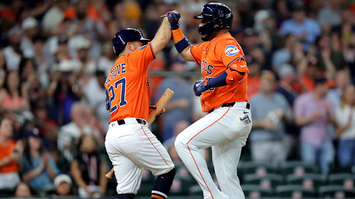 May 23, 2025; Houston, Texas, USA; Houston Astros third baseman Isaac Paredes (15) is congratulated by Houston Astros left fielder Jose Altuve (27) after hitting a two-run home run against the Seattle Mariners during the third inning at Daikin Park.