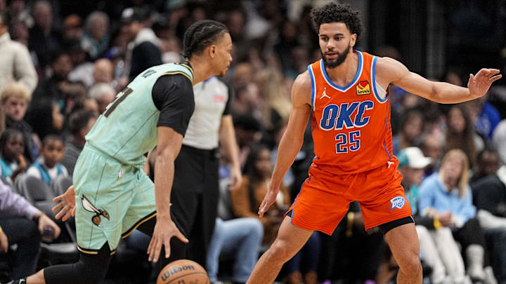 Dec 28, 2024; Charlotte, North Carolina, USA; Oklahoma City Thunder guard Ajay Mitchell (25) on defense against Charlotte Hornets guard Isaiah Wong (21) during the second half at Spectrum Center. Dec 28, 2024; Charlotte, North Carolina, USA; Oklahoma City Thunder guard Ajay Mitchell (25) on defense against Charlotte Hornets guard Isaiah Wong (21) during the second half at Spectrum Center.