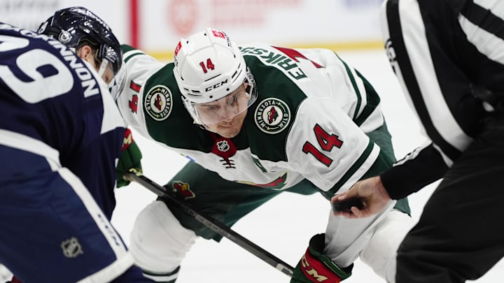 Jan 20, 2025; Denver, Colorado, USA; Minnesota Wild center Joel Eriksson Ek (14) prepares to take a face off  in the third period against the Colorado Avalanche at Ball Arena. Mandatory Credit: Ron Chenoy-Imagn Images