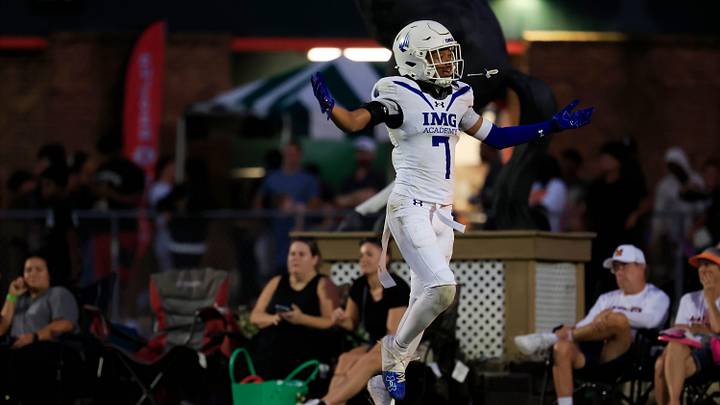 IMG Academy's Jayden Wade (7) gloats on a touchdown score to the Mandarin Mustangs fans during the second quarter of a high school football matchup at Mandarin High School, Friday, Sept. 19, 2025, in Jacksonville, Fla. The IMG Academy Ascenders defeated the Mandarin Mustangs 57-7.