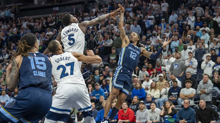 Memphis Grizzlies guard Ja Morant falls back after releasing the game-winning shot over Minnesota Timberwolves guard Anthony Edwards in the second half at Target Center in Minneapolis on Jan. 11, 2025. 