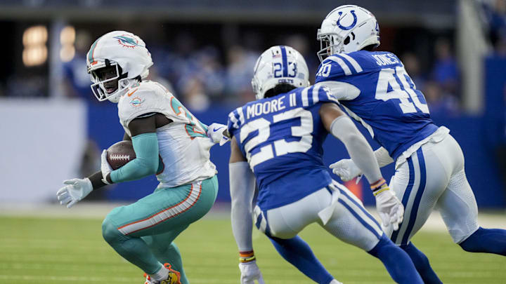 Oct 20, 2024; Indianapolis, Indiana, USA;  Indianapolis Colts cornerback Kenny Moore II (23) and Indianapolis Colts cornerback Jaylon Jones (40) work to bring down Miami Dolphins running back De'Von Achane (28) on Sunday, Oct. 20, 2024, during a game against the Miami Dolphins at Lucas Oil Stadium. Mandatory Credit: Christine Tannous/IndyStar USA TODAY Network via Imagn Images