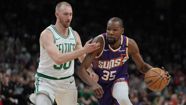 Mar 26, 2025; Phoenix, Arizona, USA; Phoenix Suns forward Kevin Durant (35) drives against Boston Celtics forward Sam Hauser (30) during the first half at Footprint Center. Mandatory Credit: Rick Scuteri-Imagn Images