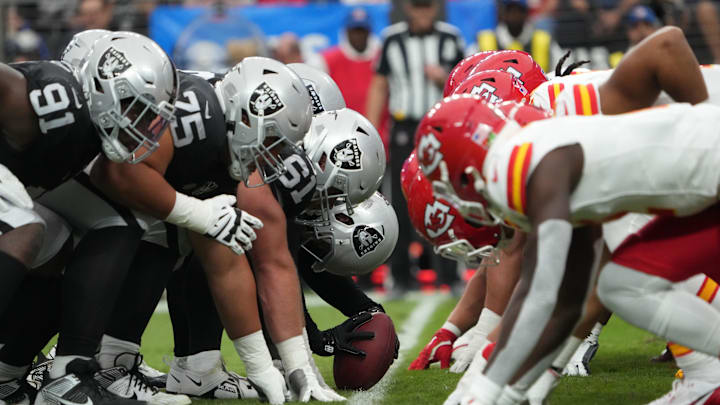 Oct 27, 2024; Paradise, Nevada, USA; Helmets at the line of scrimmage as Las Vegas Raiders long snapper Jacob Bobenmoyer (50) snaps the ball against the Kansas City Chiefs in the first half at Allegiant Stadium. Mandatory Credit: Kirby Lee-Imagn Images