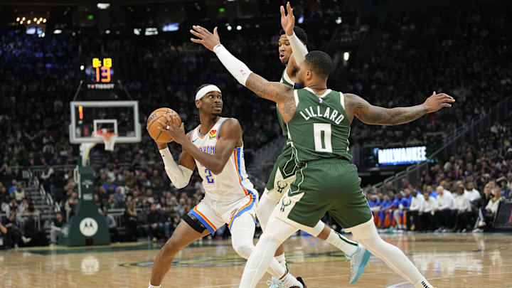 Mar 24, 2024; Milwaukee, Wisconsin, USA;  Oklahoma City Thunder guard Shai Gilgeous-Alexander (2) looks to pass the ball under pressure from Milwaukee Bucks forward Giannis Antetokounmpo (34) and guard Damian Lillard (0) during the first quarter at Fiserv Forum. Mandatory Credit: Jeff Hanisch-Imagn Images