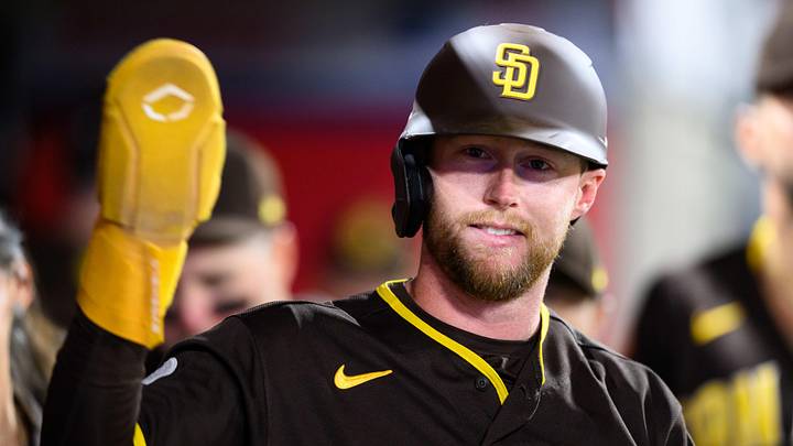 Apr 18, 2026; Anaheim, California, USA; San Diego Padres second baseman Jake Cronenworth (9) is greeted by teammates after scoring during the eighth inning against the Los Angeles Angels at Angel Stadium. Mandatory Credit: William Liang-Imagn Images