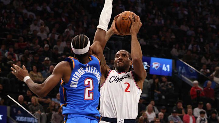 Mar 23, 2025; Inglewood, California, USA; LA Clippers forward Kawhi Leonard (2) shoots against Oklahoma City Thunder guard Shai Gilgeous-Alexander (2) during the 2nd quarter at Intuit Dome. Mandatory Credit: Jason Parkhurst-Imagn Images