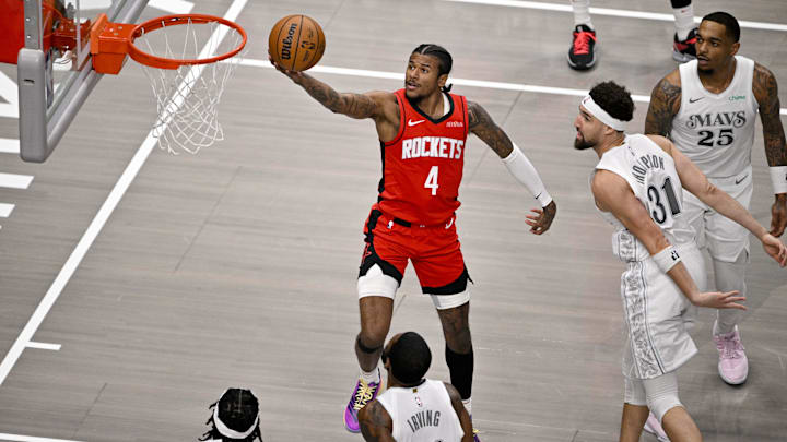 Feb 8, 2025; Dallas, Texas, USA; Houston Rockets guard Jalen Green (4) drives to the basket past Dallas Mavericks guard Klay Thompson (31) and forward P.J. Washington (25) during the first quarter at American Airlines Center. Mandatory Credit: Jerome Miron-Imagn Images