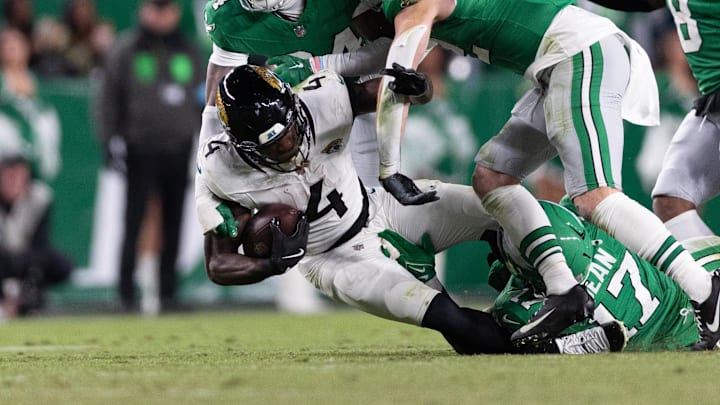 Nov 3, 2024; Philadelphia, Pennsylvania, USA; Jacksonville Jaguars running back Tank Bigsby (4) is tackled by Philadelphia Eagles linebacker Nakobe Dean (17) and cornerback Isaiah Rodgers (34) during the fourth quarter at Lincoln Financial Field. Mandatory Credit: Bill Streicher-Imagn Images Nov 3, 2024; Philadelphia, Pennsylvania, USA; Jacksonville Jaguars running back Tank Bigsby (4) is tackled by Philadelphia Eagles linebacker Nakobe Dean (17) and cornerback Isaiah Rodgers (34) during the fourth quarter at Lincoln Financial Field. Mandatory Credit: Bill Streicher-Imagn Images