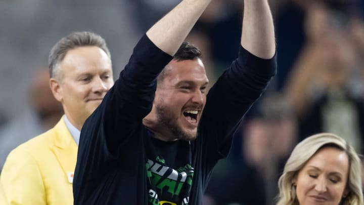 Jan 1, 2024; Glendale, AZ, USA; Oregon Ducks head coach Dan Lanning celebrates with the trophy after defeating the Liberty Flames during the 2024 Fiesta Bowl at State Farm Stadium. Mandatory Credit: Mark J. Rebilas-USA TODAY Sports