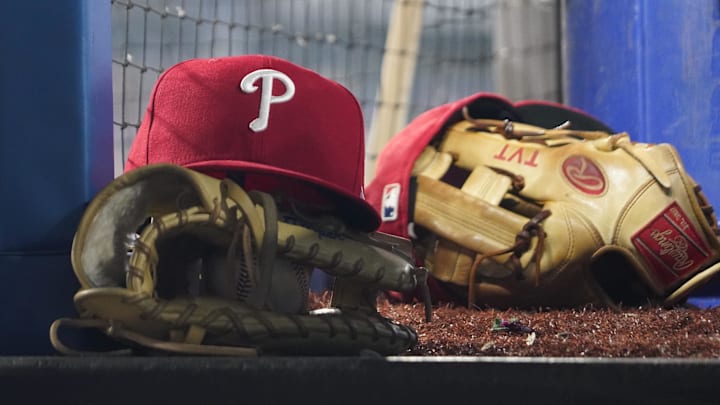 Aug 16, 2023; Toronto, Ontario, CAN; A Philadelphia Phillies cap and glove sit in the dugout during a game against the Toronto Blue Jays at Rogers Centre.