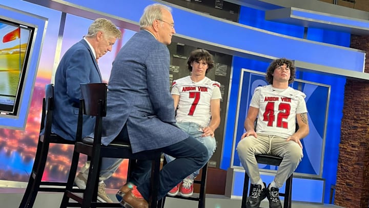 LB Christian Thatcher (42) and his brother Thaddeus sit for a TV interview.
