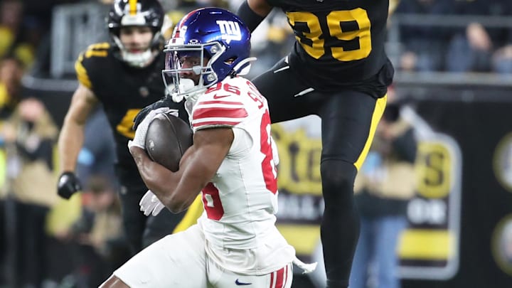 Oct 28, 2024; Pittsburgh, Pennsylvania, USA; New York Giants wide receiver Darius Slayton (86) runs after a catch as Pittsburgh Steelers safety Minkah Fitzpatrick (39) chases during the second quarter at Acrisure Stadium.  