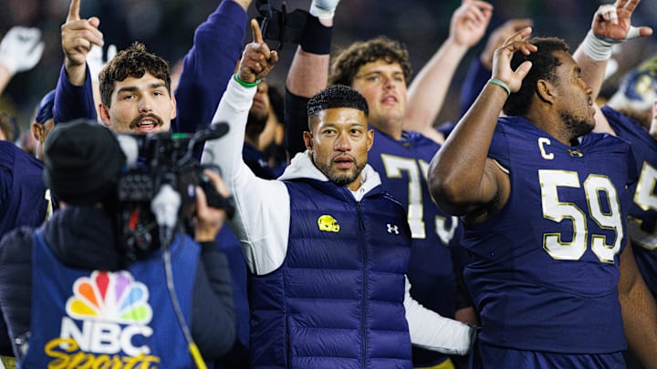 Notre Dame head coach Marcus Freeman celebrates with his players after winning a NCAA football game 70-7 against Syracuse at Notre Dame Stadium on Saturday, Nov. 22, 2025, in South Bend. Notre Dame head coach Marcus Freeman celebrates with his players after winning a NCAA football game 70-7 against Syracuse at Notre Dame Stadium on Saturday, Nov. 22, 2025, in South Bend.