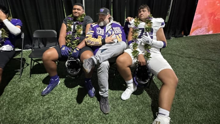 Elijah Vaikona (72) sits next to fellow recruit Darius Afalava and Husky line coach Brennan Carroll on his official UW visit.
