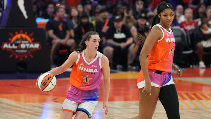 Jul 20, 2024; Phoenix, AZ, USA; Team WNBA guard Caitlin Clark (22) dribbles alongside Team WNBA forward Angel Reese (5) against USA Women's National Team during the WNBA All Star Game at Footprint Center. Mandatory Credit: Joe Camporeale-Imagn Images