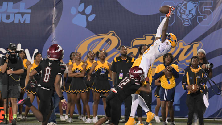 Miami Northwestern's Calvin Russell Jr. leaps for a tough catch attempt during the first half of the Class 3A state championship on Dec. 14, 2024.