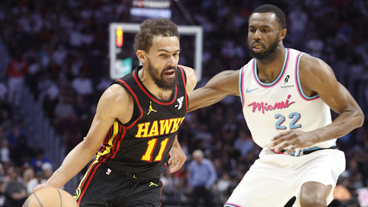Mar 27, 2025; Miami, Florida, USA;  Miami Heat forward Andrew Wiggins (22) defends Atlanta Hawks guard Trae Young (11) during the second half at Kaseya Center. Mandatory Credit: Rhona Wise-Imagn Images