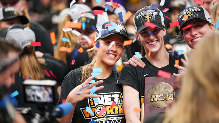 Iowa Hawkeyes guard Gabbie Marshall (24) guard Caitlin Clark (22) and guard Kate Martin (20) hold the trophy after beating LSU in the Elite 8 round of the NCAA Women's Basketball Tournament between Iowa and LSU at MVP Arena, Monday, April 1, 2024 in Albany, N.Y.