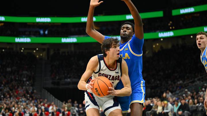 Dec 13, 2025; Seattle, Washington, USA; Gonzaga Bulldogs forward Braden Huff (34) is guarded by UCLA Bruins center Xavier Booker (1) during the first half at Climate Pledge Arena Dec 13, 2025; Seattle, Washington, USA; Gonzaga Bulldogs forward Braden Huff (34) is guarded by UCLA Bruins center Xavier Booker (1) during the first half at Climate Pledge Arena