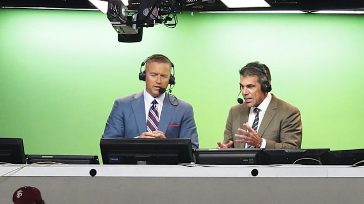 Aug 30, 2014; Arlington, TX, USA; ESPN broadcasters Kirk Herbstreit (right) and Chris Fowler announce the game with the Florida State Seminoles playing against the Oklahoma State Cowboys at AT&T Stadium. Mandatory Credit: Matthew Emmons-Imagn Images
