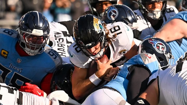 Nov 30, 2025; Nashville, Tennessee, USA;  Jacksonville Jaguars quarterback Trevor Lawrence (16) dives for a first down against the Tennessee Titans during the second half at Nissan Stadium. Mandatory Credit: Steve Roberts-Imagn Images
