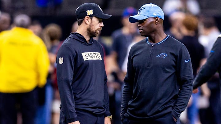 New Orleans Saints offensive coordinator Klint Kubiak talks to Carolina Panthers defensive coordinator Ejiro Evero New Orleans Saints offensive coordinator Klint Kubiak talks to Carolina Panthers defensive coordinator Ejiro Evero