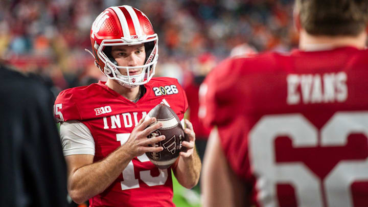 Indiana's Fernando Mendoza (15) gets loose before the College Football Playoff National Championship college football game at Hard Rock Stadium in Miami Gardens on Monday, Jan. 19, 2026.