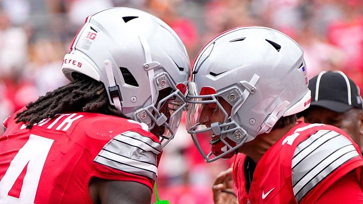 Ohio State Buckeyes wide receiver Jeremiah Smith (4) celebrates with quarterback Julian Sayin (10) after Smith scored a touchdown. Ohio State Buckeyes wide receiver Jeremiah Smith (4) celebrates with quarterback Julian Sayin (10) after Smith scored a touchdown.