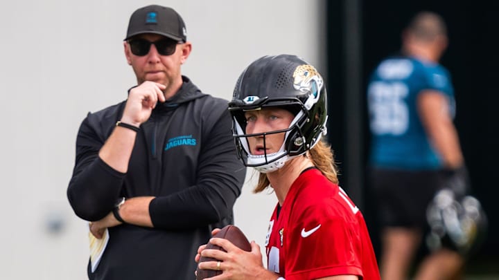 Jacksonville Jaguars quarterback Trevor Lawrence (16) falls back as Jacksonville Jaguars head coach Liam Coen watches during the Jacksonville Jaguars’ mandatory minicamp Tuesday June 10, 2025 at the Miller Electric Center in Jacksonville, Fla. [Doug Engle/Florida Times-Union]