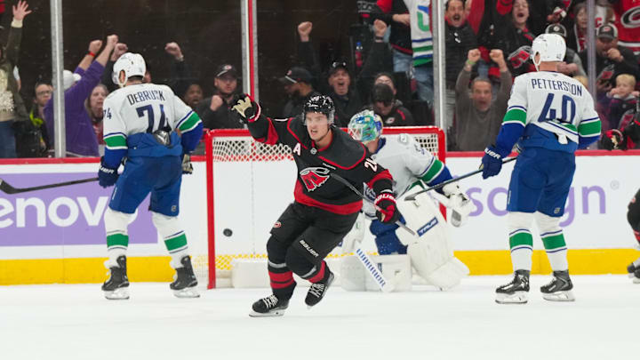 Nov 14, 2025; Raleigh, North Carolina, USA;  Carolina Hurricanes center Sebastian Aho (20) celebrates his game winning over time goal against the Vancouver Canucks at Lenovo Center. Mandatory Credit: James Guillory-Imagn Images