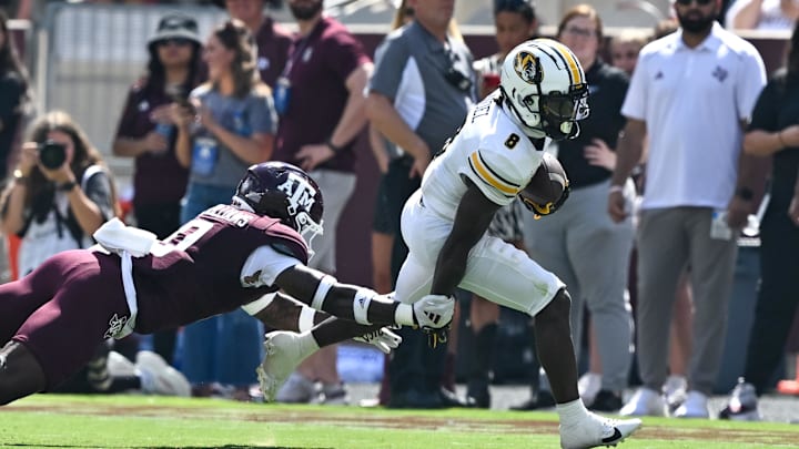 Oct 5, 2024; College Station, Texas, USA; Texas A&M Aggies linebacker Scooby Williams (0) tackles Missouri Tigers running back Nate Noel (8) in the third quarter at Kyle Field. Mandatory Credit: Maria Lysaker-Imagn Images. 