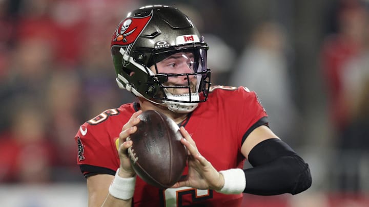 Jan 12, 2025; Tampa, Florida, USA; Tampa Bay Buccaneers quarterback Baker Mayfield (6) rolls out during the first quarter of a NFC wild card playoff against the Washington Commanders at Raymond James Stadium. Mandatory Credit: Nathan Ray Seebeck-Imagn Images