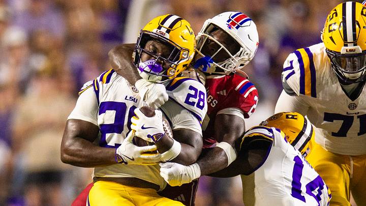 Sep 6, 2025; Baton Rouge, Louisiana, USA; LSU Tigers running back Kaleb Jackson (28) is tackled by Louisiana Tech Bulldogs during the second half at Tiger Stadium. Mandatory Credit: Stephen Lew-Imagn Images Sep 6, 2025; Baton Rouge, Louisiana, USA; LSU Tigers running back Kaleb Jackson (28) is tackled by Louisiana Tech Bulldogs during the second half at Tiger Stadium. Mandatory Credit: Stephen Lew-Imagn Images