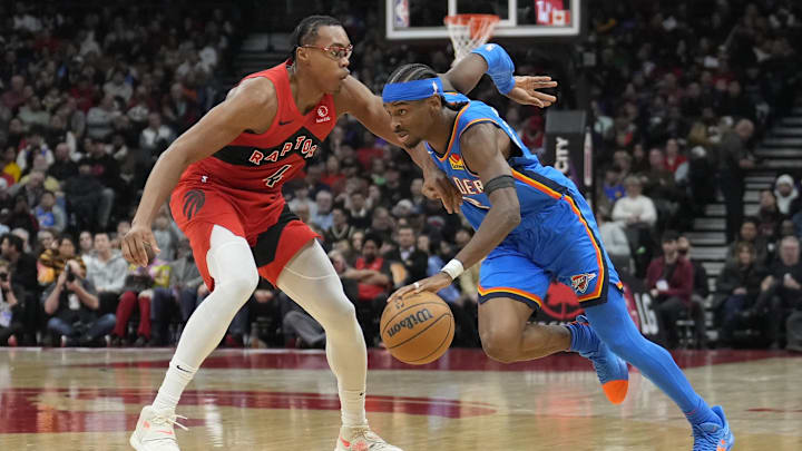 Dec 5, 2024; Toronto, Ontario, CAN; Oklahoma City Thunder guard Shai Gilgeous-Alexander (2) drives to the net against Toronto Raptors forward Scottie Barnes (4) during the second half at Scotiabank Arena. Mandatory Credit: John E. Sokolowski-Imagn Images
