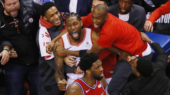 May 12, 2019; Toronto, Ontario, CAN; Toronto Raptors forward Kawhi Leonard (middle) is congratulated after making the game winning basket against Philadelphia 76ers center Joel Embiid (21) during game seven of the second round of the 2019 NBA Playoffs at Scotiabank Arena. Toronto defeated Philadelphia. Mandatory Credit: John E. Sokolowski-Imagn Images May 12, 2019; Toronto, Ontario, CAN; Toronto Raptors forward Kawhi Leonard (middle) is congratulated after making the game winning basket against Philadelphia 76ers center Joel Embiid (21) during game seven of the second round of the 2019 NBA Playoffs at Scotiabank Arena. Toronto defeated Philadelphia. Mandatory Credit: John E. Sokolowski-Imagn Images