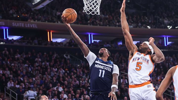 Jan 17, 2025; New York, New York, USA; Minnesota Timberwolves center Naz Reid (11) drives past New York Knicks forward Precious Achiuwa (5) for a layup attempt in the first quarter at Madison Square Garden. Mandatory Credit: Wendell Cruz-Imagn Images