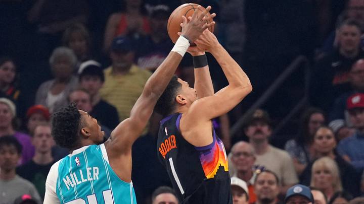 Charlotte Hornets forward Brandon Miller (24) blocks a shot attempt by Phoenix Suns guard Devin Booker Charlotte Hornets forward Brandon Miller (24) blocks a shot attempt by Phoenix Suns guard Devin Booker