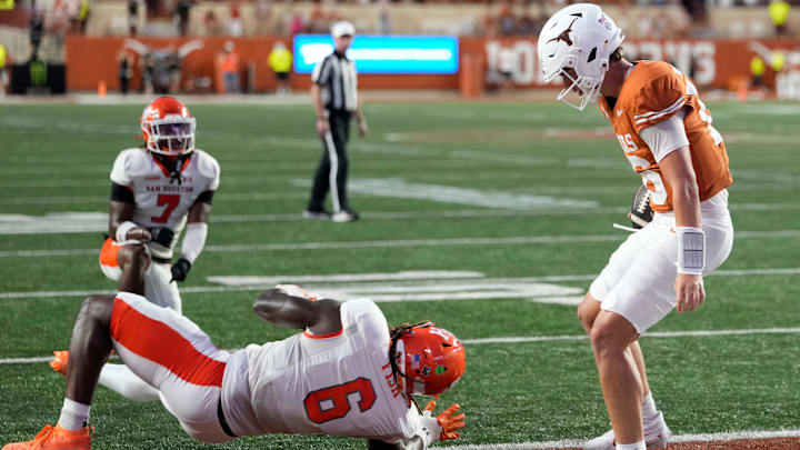 Sep 20, 2025; Austin, Texas, USA; Texas Longhorns quarterback Arch Manning (16) runs in for a touchdown past Sam Houston Bearkats linebacker Antivirus Fish (6) during the first half at Darrell K Royal-Texas Memorial Stadium. Mandatory Credit: Scott Wachter-Imagn Images