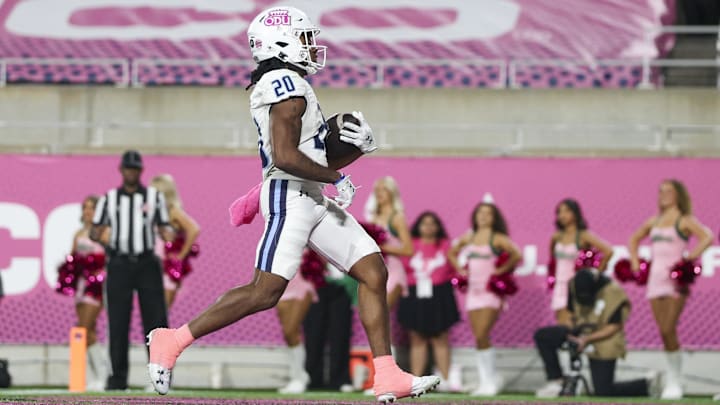 Dec 17, 2025; Orlando, FL, USA; Old Dominion Monarchs running back Trequan Jones (20) scores a touchdown against the South Florida Bulls in the third quarter during the Cure Bowl at Camping World Stadium.