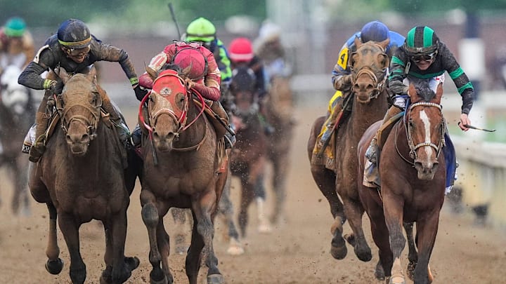 Near the finish line, jockey Tyler Gaffalione, left, and Forever Young's jockey Ryusei Sakai crowd after the two horses bumped and Mystik Dan with jockey Brian J. Hernandez, right, won the 2024 Kentucky Derby at Churchill Downs.