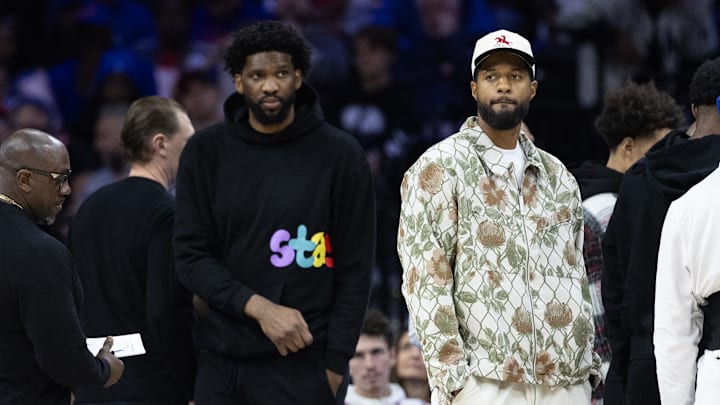 Nov 2, 2024; Philadelphia, Pennsylvania, USA; Injured Philadelphia 76ers Paul George (R) and Joel Embiid (L) look on during the first quarter against the Memphis Grizzlies at Wells Fargo Center. Mandatory Credit: Bill Streicher-Imagn Images