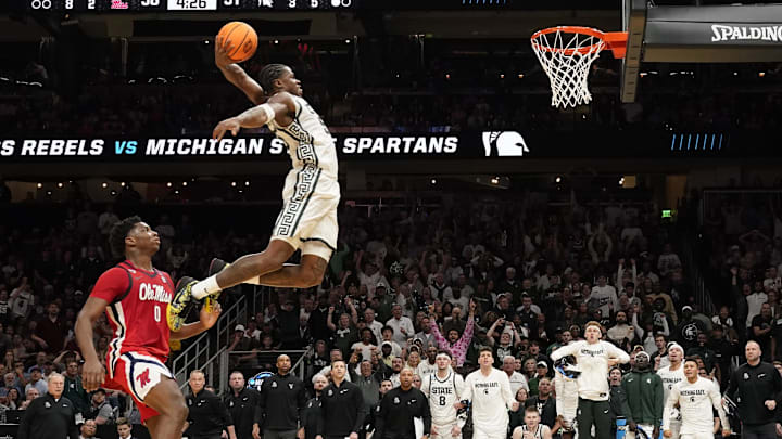 Mar 28, 2025; Atlanta, GA, USA; Michigan State Spartans forward Coen Carr (55) dunks against Mississippi Rebels forward Malik Dia (0) in the second half of a South Regional semifinal of the 2025 NCAA tournament at State Farm Arena. Mandatory Credit: Dale Zanine-Imagn Images