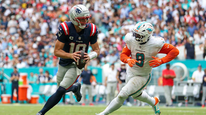 Sep 14, 2025; Miami Gardens, Florida, USA; New England Patriots quarterback Drake Maye (10) runs the ball chased by Miami Dolphins linebacker Matthew Judon (8) in the third quarter at Hard Rock Stadium. Mandatory Credit: Nathan Ray Seebeck-Imagn Images