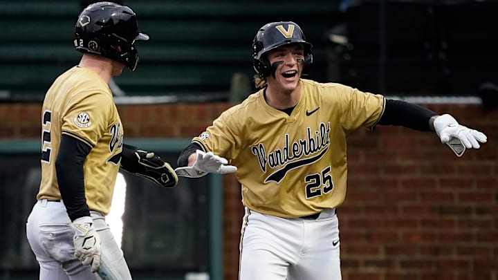 Vanderbilt designated hitter Mack Whitcomb (25) celebrates scoring with right fielder Logan Johnstone (2) on a single hit by catcher Colin Barczi during the first inning against Eastern Michigan at Hawkins Field in Nashville, Tenn., Wednesday, Feb. 18, 2026.