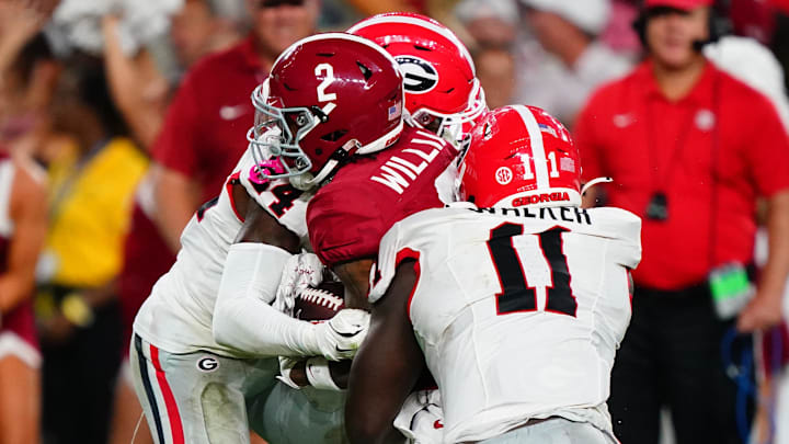 Sep 28, 2024; Tuscaloosa, Alabama, USA;  Alabama Crimson Tide wide receiver Ryan Williams (2) is tackled by Georgia Bulldogs defensive back Malaki Starks (24) and linebacker Jalon Walker (11) during the third quarter at Bryant-Denny Stadium. 