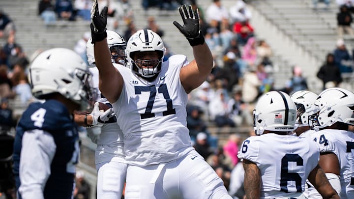 Penn State offensive lineman Vega Ioane (71) celebrates with running back Quinton Martin after the freshman scored a touchdown during the Blue-White game at Beaver Stadium on Saturday, April 13, 2024, in State College. The White team defeated the Blue team, 27-0.