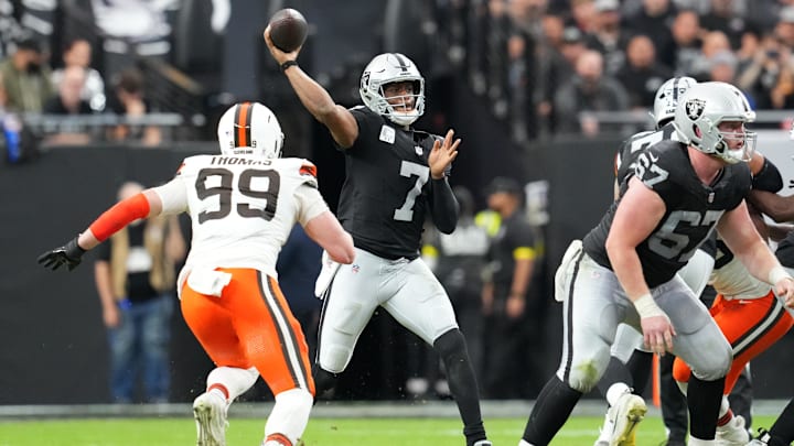 Nov 23, 2025; Paradise, Nevada, USA; Las Vegas Raiders quarterback Geno Smith (7) passes against Cleveland Browns defensive end Cameron Thomas (99) in the first half at Allegiant Stadium. Mandatory Credit: Stephen R. Sylvanie-Imagn Images